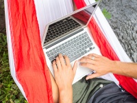 Student with laptop in a hammock