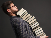 Man balancing a stack of books