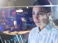 Portrait of a student while looking at a screen with holograms, office scene in the background