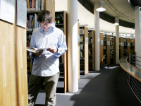 Student between book shelves