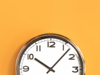 Wall clock on orange background