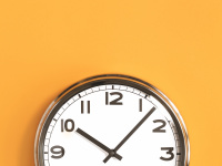 Wanduhr auf orangem Hintergrund