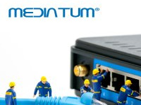 Miniature figures with internet cable in front of a switch box and mediaTUM writing above