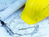 Construction plans and yellow safety helmet