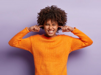 Girl covers her ears