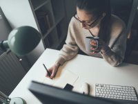 Young woman working on computer at her home office