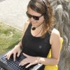 Student outside with laptop and headset