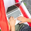 Student with laptop in a hammock