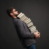 Man balancing a stack of books