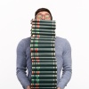 Man balancing a stack of books