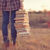 Female student with a pile of books