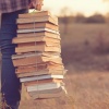 Female student with a pile of books