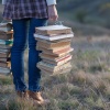 Female student with a pile of books