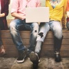 Students sitting next to each other with tablets and notebooks