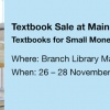 Frau mit Bücherstapel, text Textbook Sale at Main Campus