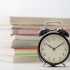 Alarm clock and stack of books