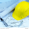 Construction plans and yellow safety helmet