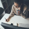 Young woman working on computer at her home office